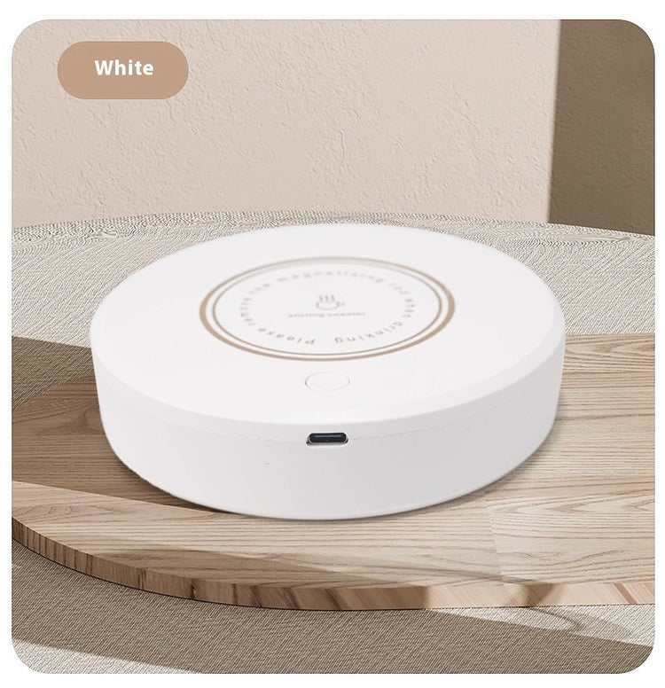 Rechargeable magnetic coffee stirring coaster from Bucciato, a smart kitchen gadget for automatic beverage stirring.