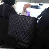 Bucciato car seat storage organizer holding a handbag in a vehicle, with multiple compartments for tidying and stowing accessories.
