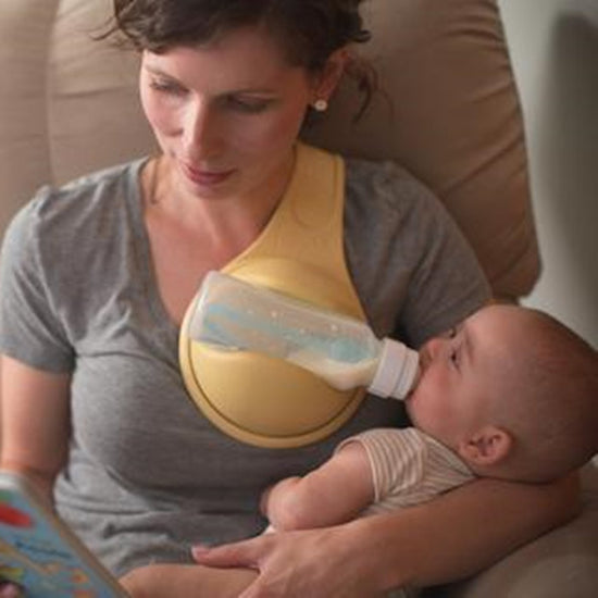 Baby bottle holder from Bucciato, hands-free feeding accessory with adjustable strap and secure clip for easy feeding.
