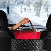 Car seat storage organizer by Bucciato holding handbags, designed to keep auto interior tidy and prevent clutter.