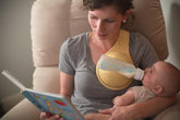 Baby bottle holder by Bucciato, hands-free feeding accessory with adjustable straps and secure grip for convenient baby feeding.