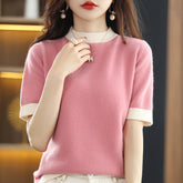 Wool knitted half turtleneck top with loose fit, short sleeves, in a neutral color, designed for casual wear.