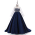 Girls’ mesh long sleeve trailing dress by Bucciato, stylish occasion wear with delicate mesh fabric and flowing design.