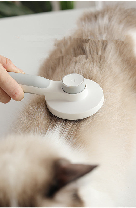 Round handle pet massage comb with ergonomic design, ideal for grooming and detangling cats and dogs.