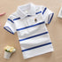 Boy wearing a navy college style polo short sleeve T-shirt from Bucciato Multi-Product Store, casual and comfortable for everyday wear.