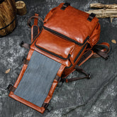 Large capacity cowhide shoulder computer bag with flip design, featuring multiple compartments and sturdy straps for everyday use.