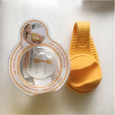 Baby bottle holder from Bucciato, hands-free feeding accessory with adjustable strap and secure grip for easy baby feeding.