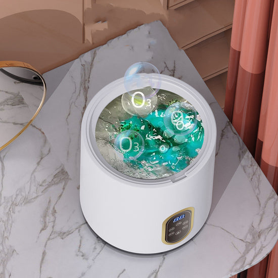 Small mini automatic washing machine for children, compact appliance with control panel and drum for gentle laundry care