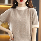 Loose short-sleeve wool knitted half turtleneck top in neutral tones, featuring a cozy, relaxed fit and textured knit pattern.