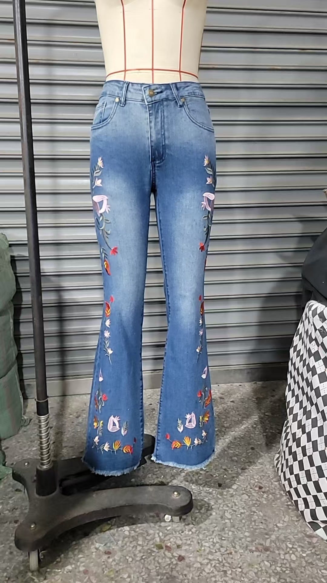 High-elasticity embroidered flared jeans for women, luxury designer denim with intricate embroidery, shown on a model.