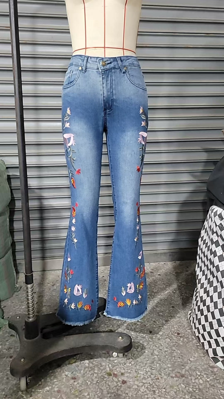 High-elasticity embroidered flared jeans for women, luxury designer denim with intricate embroidery, shown on a model.