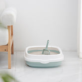 High-quality Pet Toilet Cat Litter Box with scoop, anti-splash plastic design for cats and small dogs, durable and easy to clean.