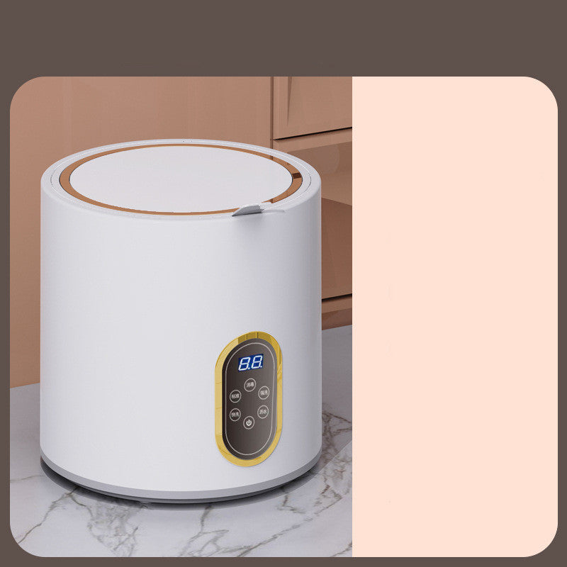 Small mini automatic washing machine for children by Bucciato, compact appliance with control panel and drum for laundry.