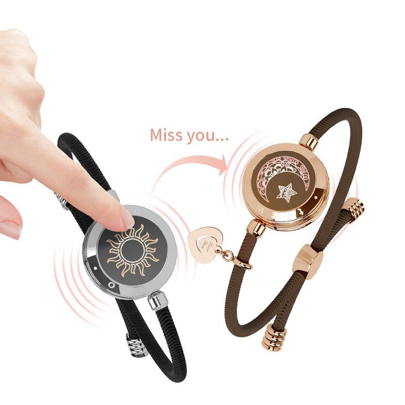 Sun-Moon Smart Sensing Couple Bracelet by Bucciato, close-up of sleek design with glowing sensors on a black band.