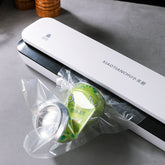 Small Bucciato household vacuum packaging machine with control panel and sealing area for food storage and preservation.