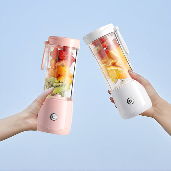 Mini electric portable juice machine by Bucciato, compact design with a transparent container, ready for fresh juice blending.