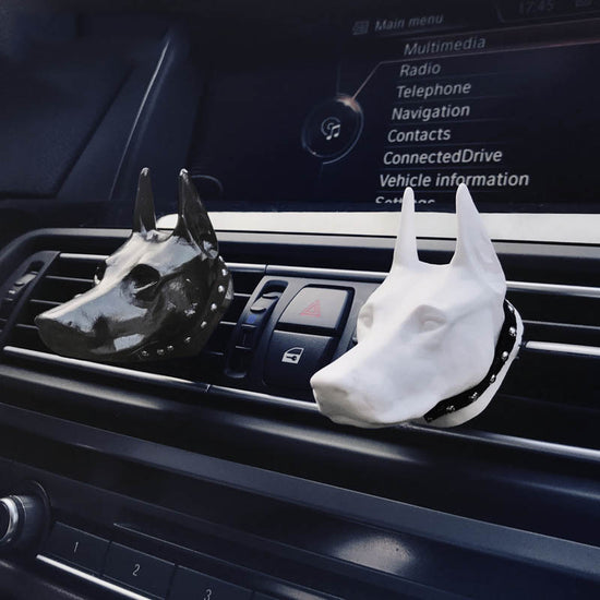 Doberman-shaped car air freshener clip by Bucciato, a creative interior accessory for freshening car air outlets.