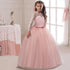 Long flower girl dress for kids by Bucciato, featuring floral details and a flowing, elegant design for special occasions.