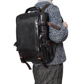 Large cowhide flip shoulder computer bag in brown with multiple compartments, designed for high capacity and stylish carrying.