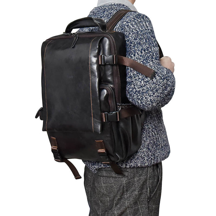 Large cowhide flip shoulder computer bag in brown with multiple compartments, designed for high capacity and stylish carrying.