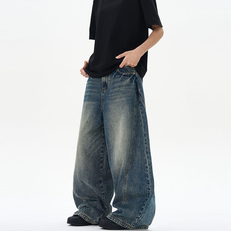 American-style vintage blue washed tie-dye bootcut jeans with a relaxed fit and faded wash, displayed on a hanger.
