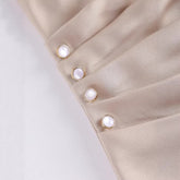 Women’s casual short sleeve top by Bucciato, minimalist design with a relaxed fit, shown in a neutral color on a model.