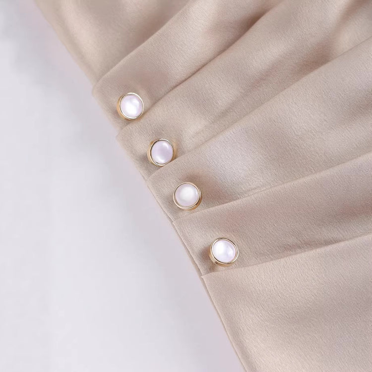 Women’s casual short sleeve top by Bucciato, minimalist design with a relaxed fit, shown in a neutral color on a model.