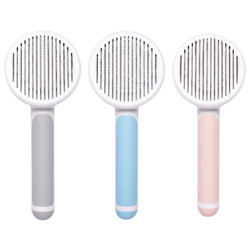 Round handle pet massage comb with stainless steel teeth for gentle grooming and de-shedding of dogs and cats.