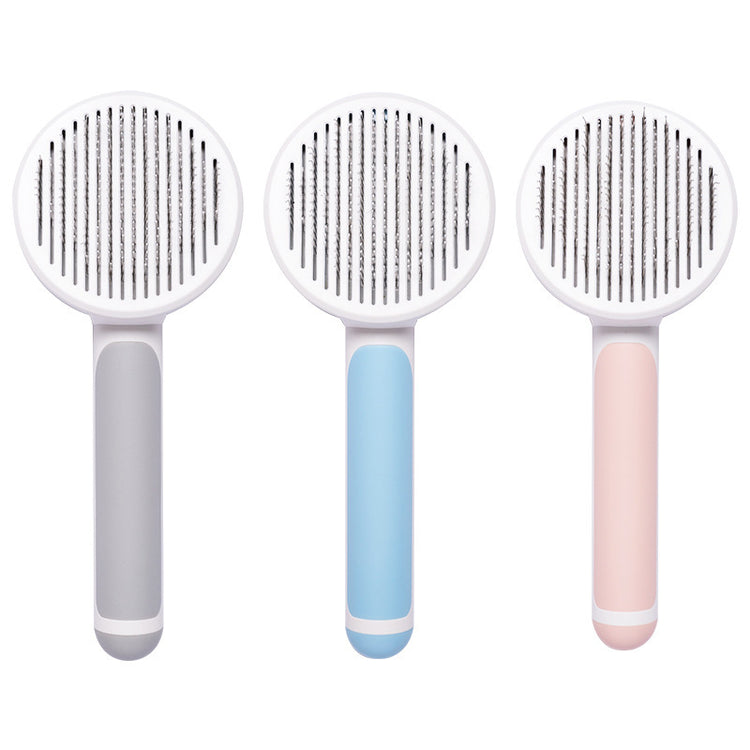 Round handle pet massage comb with stainless steel teeth for gentle grooming and de-shedding of dogs and cats.