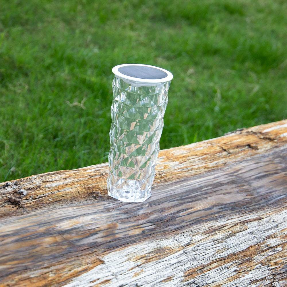 Solar Garden Lamp with a clear faceted crystal-style cylindrical body and round black solar panel on top