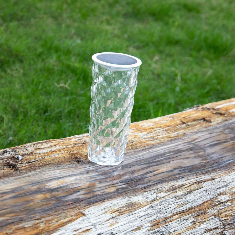 Solar Garden Lamp with a clear faceted crystal-style cylindrical body and round black solar panel on top